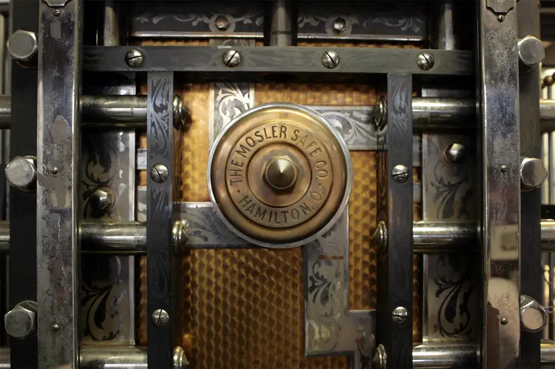 A heavy vault door with brass handles
